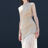 Beige sleeveless maxi dress paired with white lace layered skirt chic California fashion for women