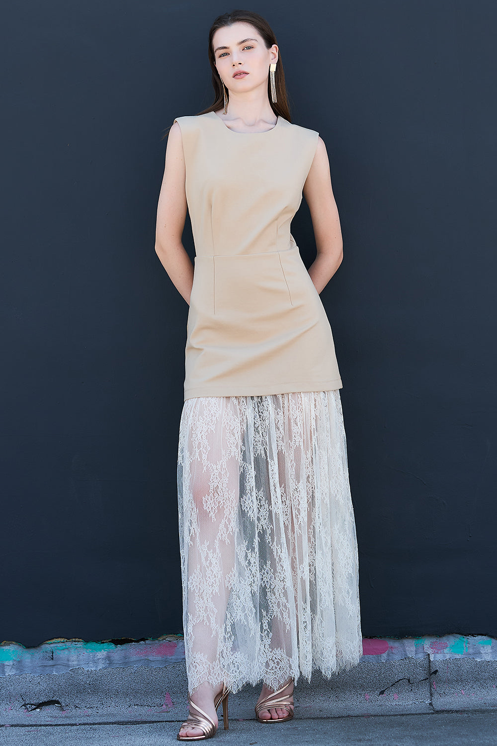 Front view of taupe sleeveless mini dress layered with sheer lace maxi skirt women’s trendy fashion outfit
