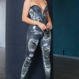 Side profile of a woman in a deep V bustier denim-look top and fitted leggings set black by StyleVava.