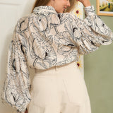 STYLEVAVA navy floral balloon sleeve blouse with tie-neck, model wearing size S