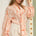 STYLEVAVA orange floral balloon sleeve blouse with tie-neck, model wearing size S