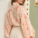 STYLEVAVA orange floral balloon sleeve blouse with tie-neck, model wearing size S