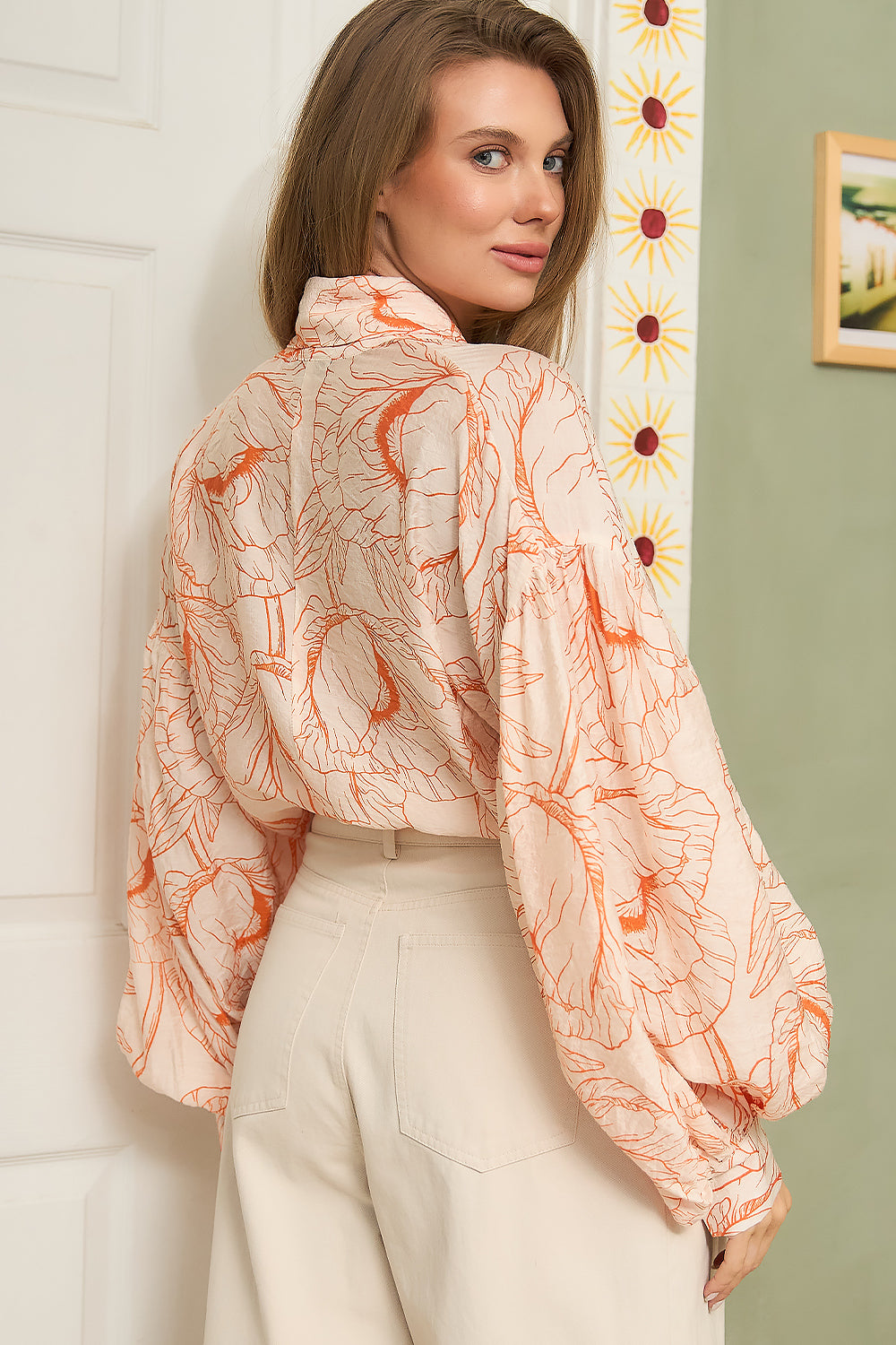 STYLEVAVA orange floral balloon sleeve blouse with tie-neck, model wearing size S