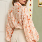 STYLEVAVA orange floral balloon sleeve blouse with tie-neck, model wearing size S