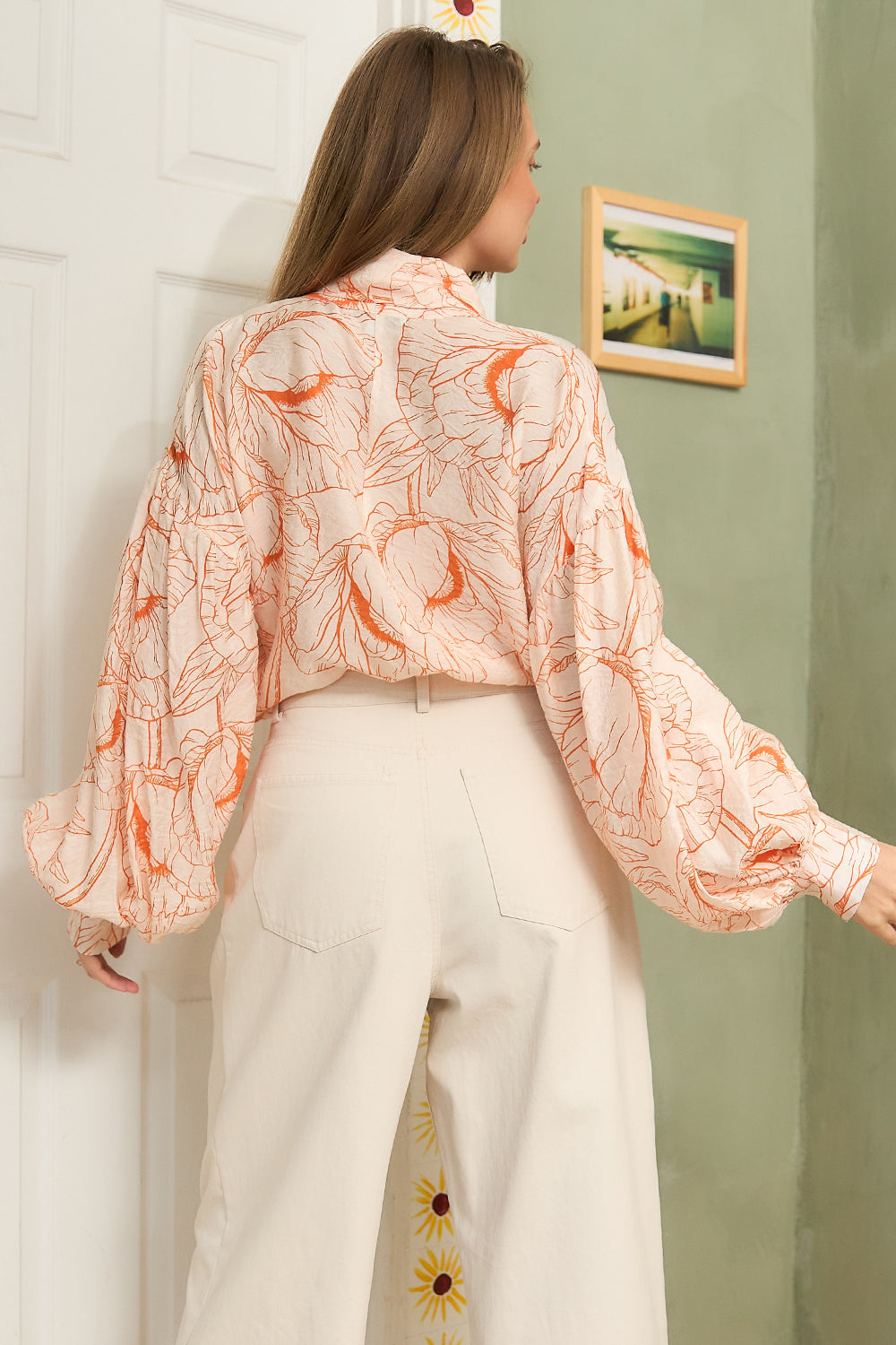 STYLEVAVA orange floral balloon sleeve blouse with tie-neck, model wearing size S