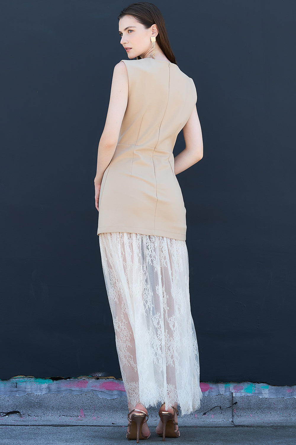 Back view of taupe sleeveless dress with layered lace maxi skirt – elegant women’s evening wear